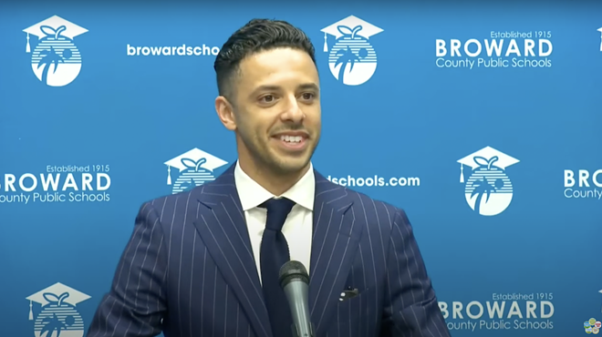 Broward School Board Daniel Foganholi candidate at a speaking podium.